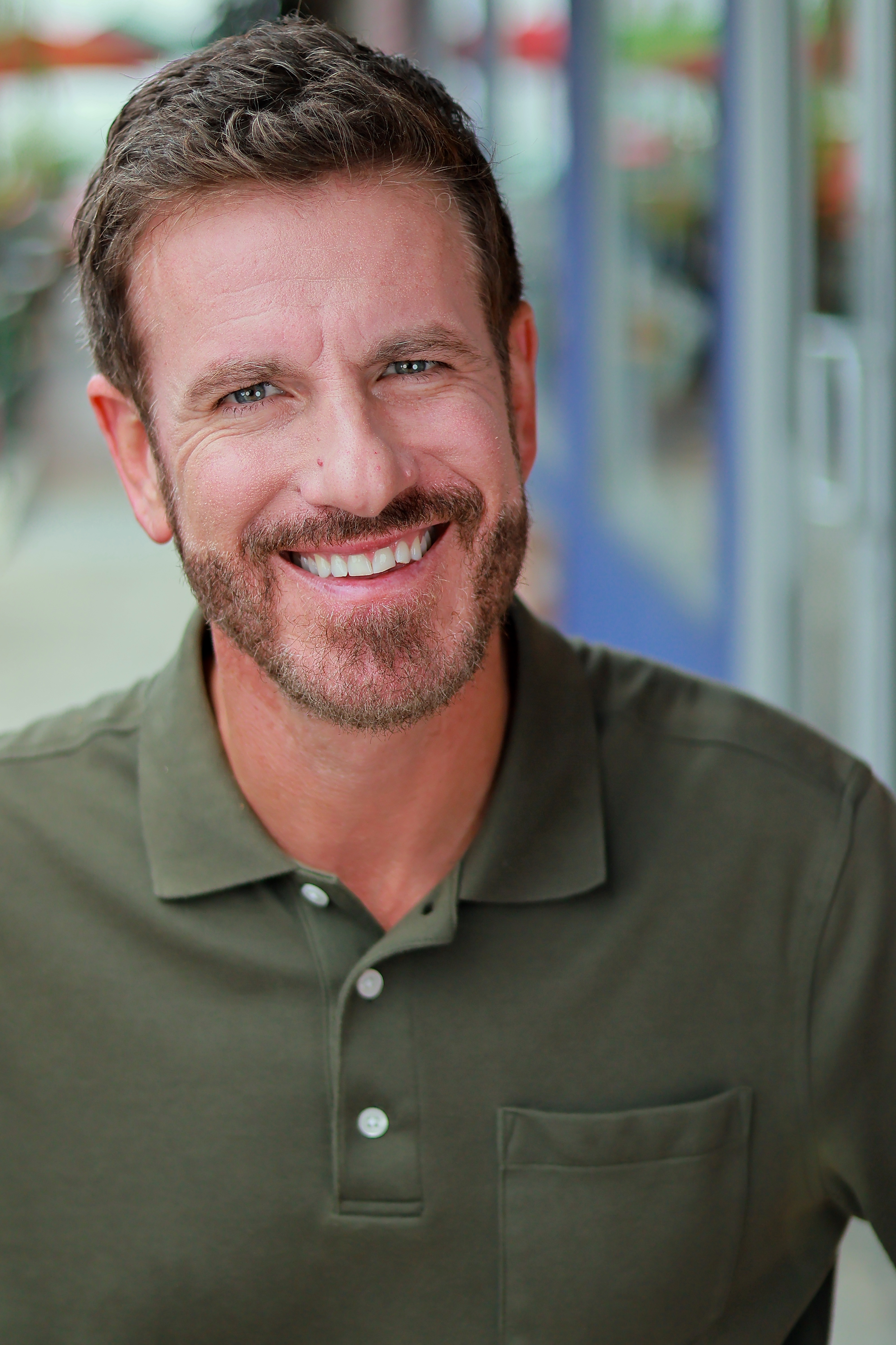 Tyler Haines smiling in a green polo
